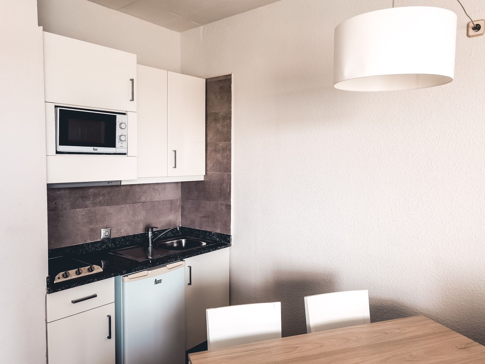 Apartament with small kitchen, modern interior design, hotel, summertime